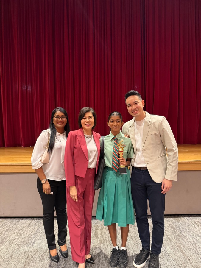 A student with her mentors after an award