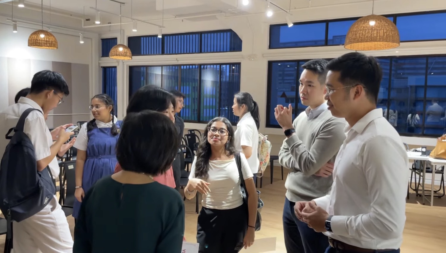 A mentor in conversation with students at Mind Stretcher